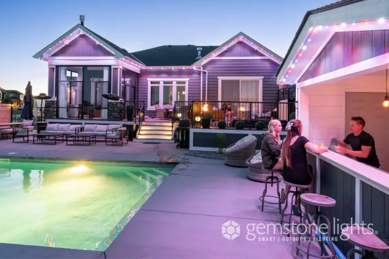 Color-changing LED lighting illuminating a stylish backyard and pool area at dusk