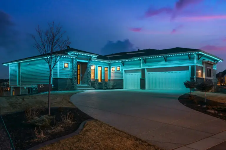 Gemstone Lights illuminating a house exterior with vibrant blue LED soffit lighting