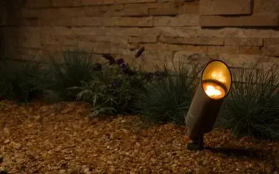FX Luminaire MR-16 LED spotlight illuminating stone landscaping and ornamental grasses