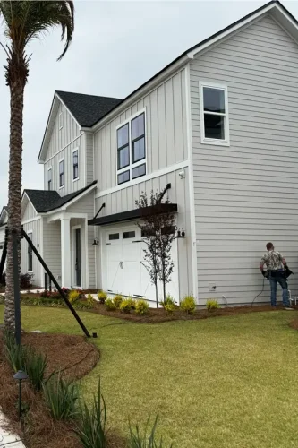Emerald Coast Illumination technician preparing landscape lighting install at modern home in Panama City