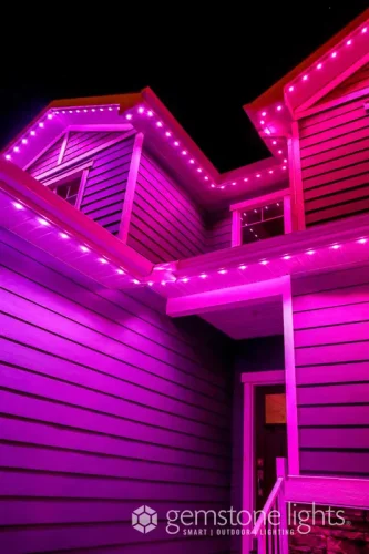 Home exterior glowing with customizable pink LED lighting