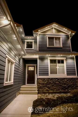 Warm white permanent LED lights illuminating home exterior at night