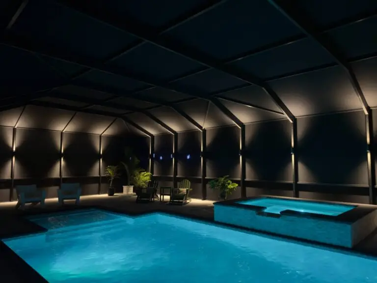 Screened pool and spa with wall uplighting and modern patio seating