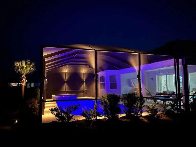 Screened pool and spa enclosure with purple and white uplighting in Panama City