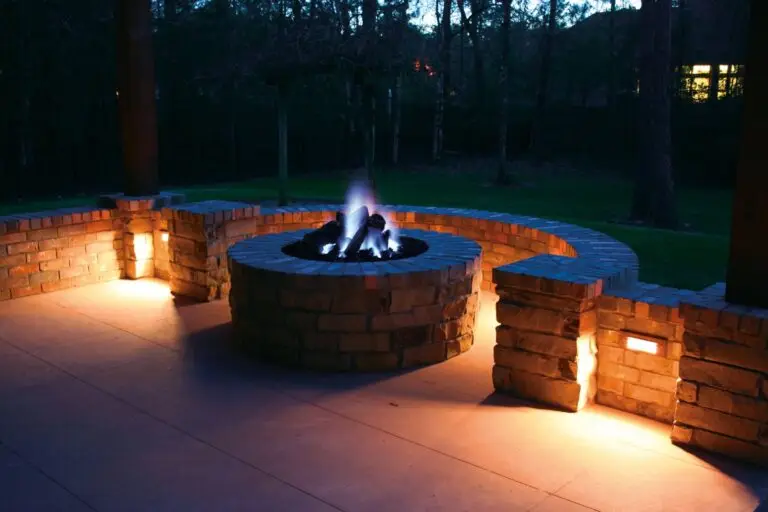 Circular brick fire pit with integrated lighting, creating a cozy outdoor ambiance