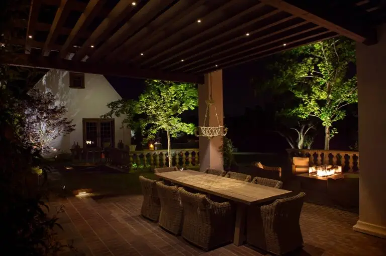 Spacious outdoor dining patio with soft lighting and fire feature for evening gatherings