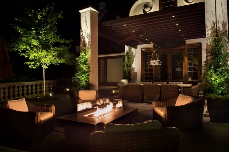 Elegant patio with soft lighting, fire feature, and cozy seating—ideal for couples