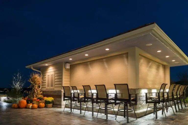 Outdoor bar with under-counter lighting and barstool seating for evening gatherings