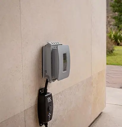 FX Luminaire transformer installed on an exterior wall for voltage check of a landscape lighting system in Panama City