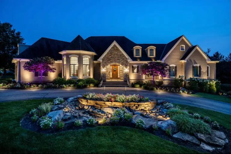 Outdoor lighting gallery featuring subtle architectural uplighting on a suburban two-story home