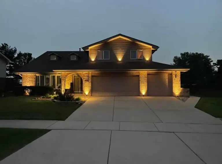 Outdoor lighting gallery view of a tiered retaining wall and landscape uplighting installation