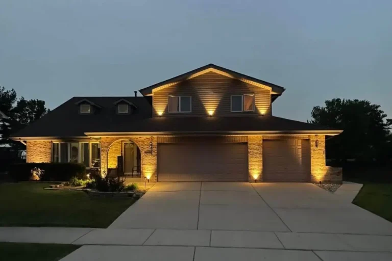 Outdoor lighting gallery view of a tiered retaining wall and landscape uplighting installation