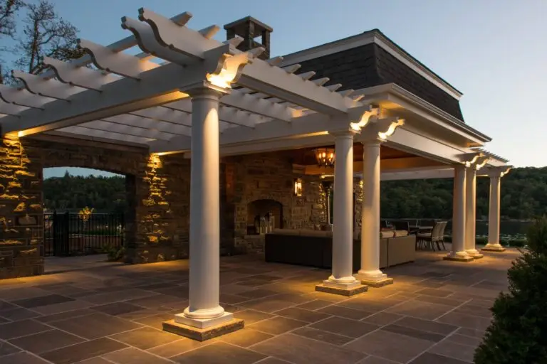 Elegant pergola and patio with architectural uplighting and stone accents