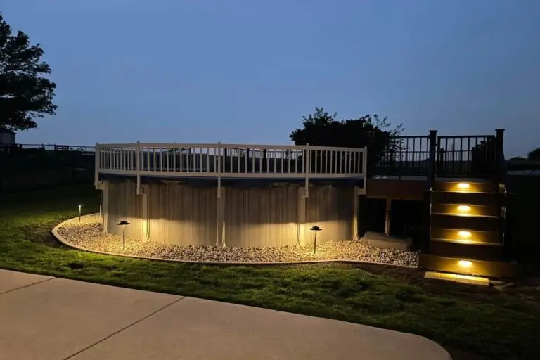Illuminated pool area with FX Luminaire path lights and step lighting around an above-ground pool in the Florida Panhandle