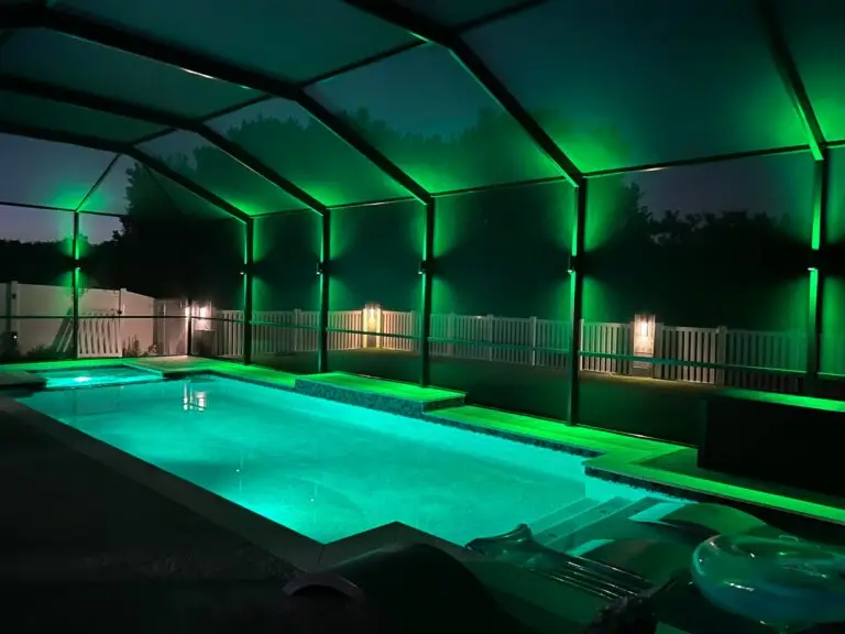 Screened pool enclosure lit with vibrant green lighting