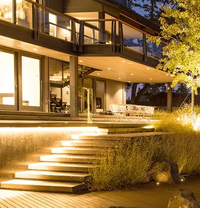 Modern home with professional outdoor lighting system illuminated at night in Panama City